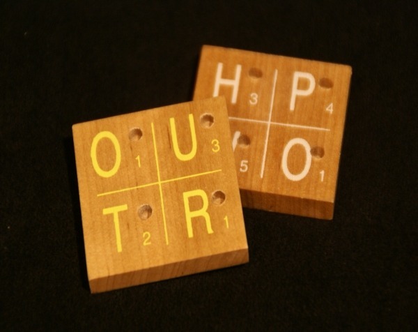 Custom wood mouldings and dimension stock made into wooden game parts with silk-screened letters, numbers, and drilled holes, available in bulk.